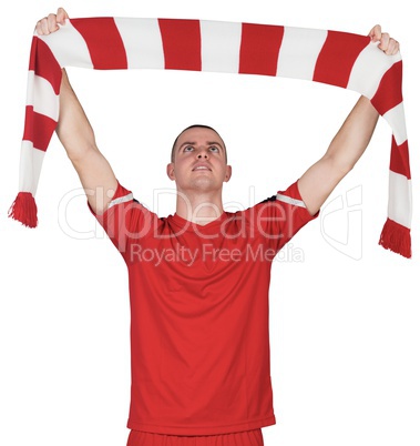 Football player holding striped scarf