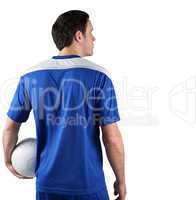 Football player in blue holding ball