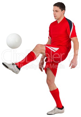 Fit young football player kicking