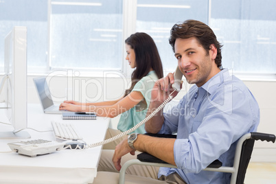 Businessman in wheelchair on telephone