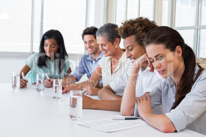 Business people writing in notebooks Business people writing in notebooks