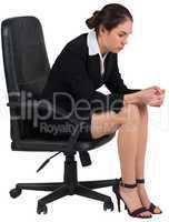 Worried businesswoman on swivel chair