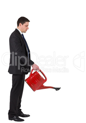 Businessman watering with red can