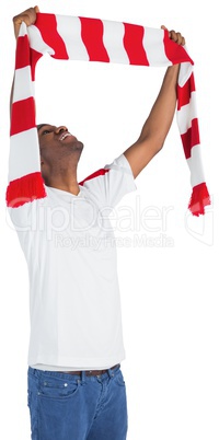 Happy football fan waving scarf