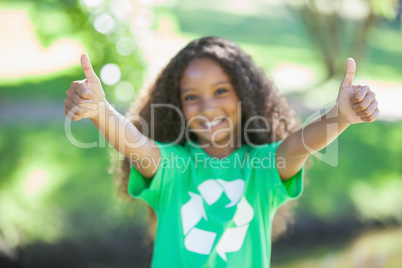 Young environmental activist smiling at the camera showing thumb