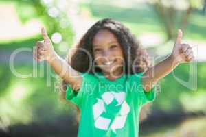 Young environmental activist smiling at the camera showing thumb