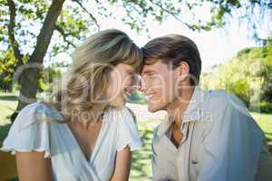 Cute couple sitting outside at a cafe head to head