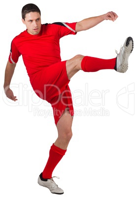 Fit young football player kicking