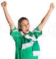 Cheering football fan in green jersey