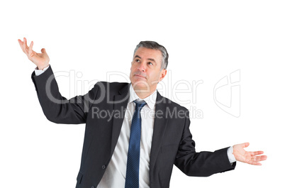 Mature businessman standing with arms out