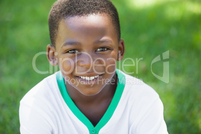 Cute boy smiling at the camera in the park