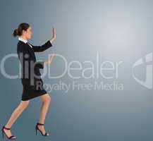 Businesswoman in suit standing and pushing