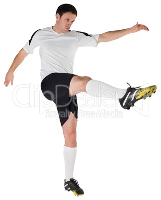 Football player in white kicking