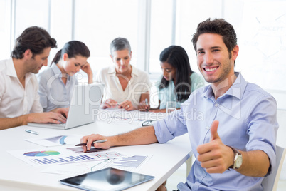 Attractive businessman smiling in the workplace