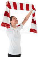 Football fan waving red and white scarf