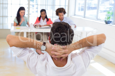 Businessman relaxed with hands behind head