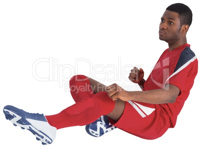 Football player in red kicking