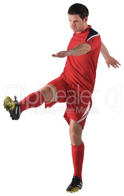 Football player in red kicking