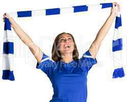 Pretty football fan waving scarf