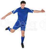 Football player in blue kicking