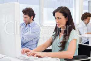 Attractive woman in wheelchair working hard on computer