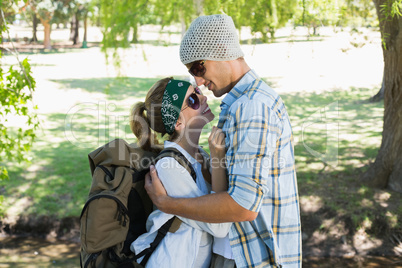 Active cute couple embracing each other on a hike smiling at eac