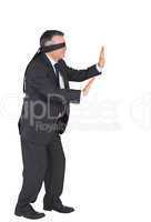 Mature businessman walking with blindfold