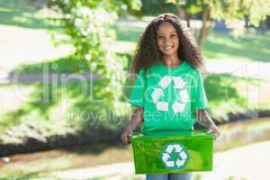 Young environmental activist smiling at the camera holding box