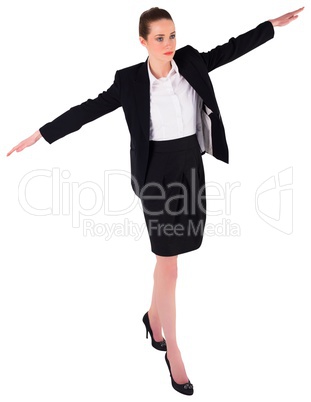 Businesswoman performing a balancing act