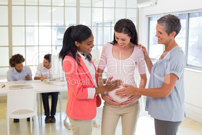 Attractive pregnant businesswoman at work