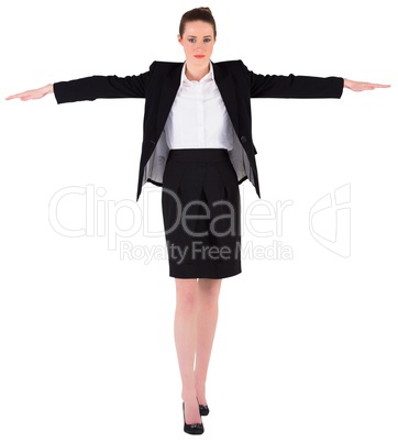 Businesswoman performing a balancing act