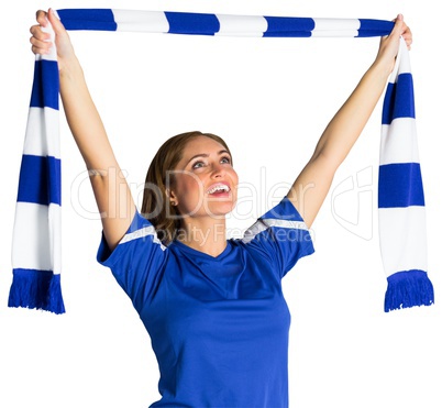 Pretty football fan waving scarf