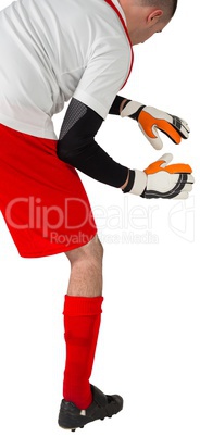 Goalkeeper in red and white ready to catch