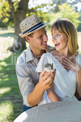 Man surprising his girlfriend with a proposal in the park