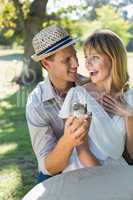 Man surprising his girlfriend with a proposal in the park