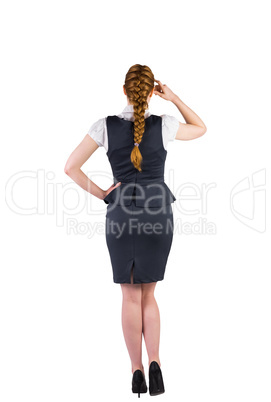 Redhead businesswoman scratching her head