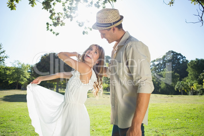 Cute couple dancing in the park and laughing