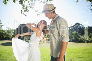 Cute couple dancing in the park and laughing