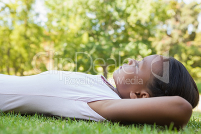 Little girl lying on the grass smiling