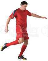 Football player in red kicking