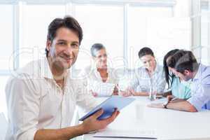 Attractive businessman using a tablet at work