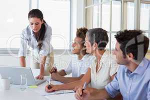 Business people using laptops and notebooks in meeting