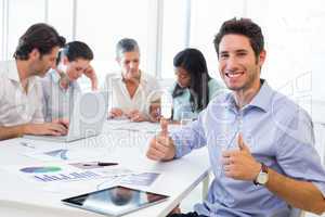 Attractive businessman smiling in the workplace