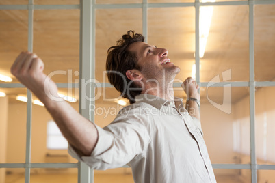 Casual smiling businessman with arms outstretched