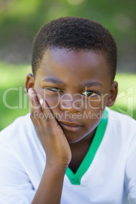 Cute boy pouting at the camera in the park