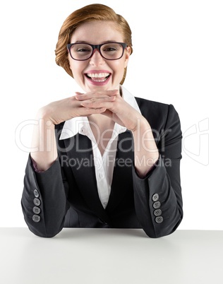 Redhead businesswoman sitting at desk