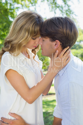 Cute couple hugging and kissing in the park