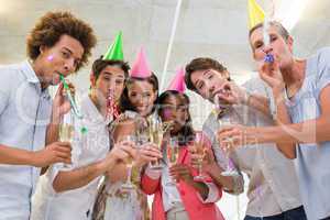 Business people celebrating at the workplace with glasses of cha