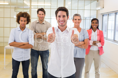 Workers giving thumbs up to camera