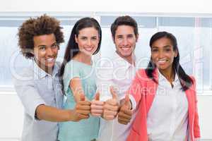 Group of workers giving thumbs up to camera